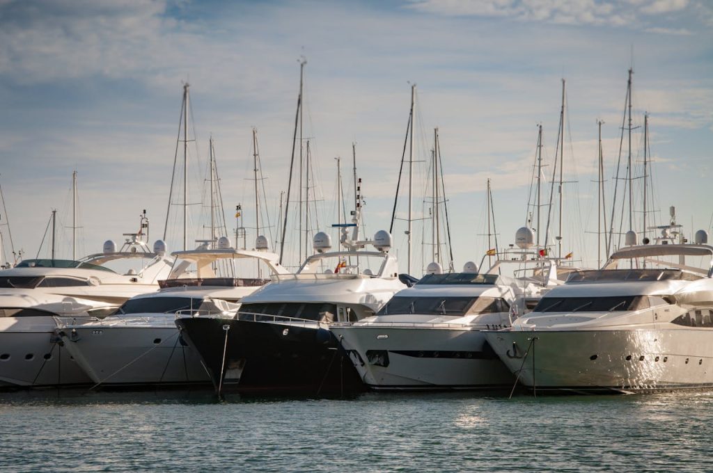 A serene marina view with luxury yachts lined up in the calm water.